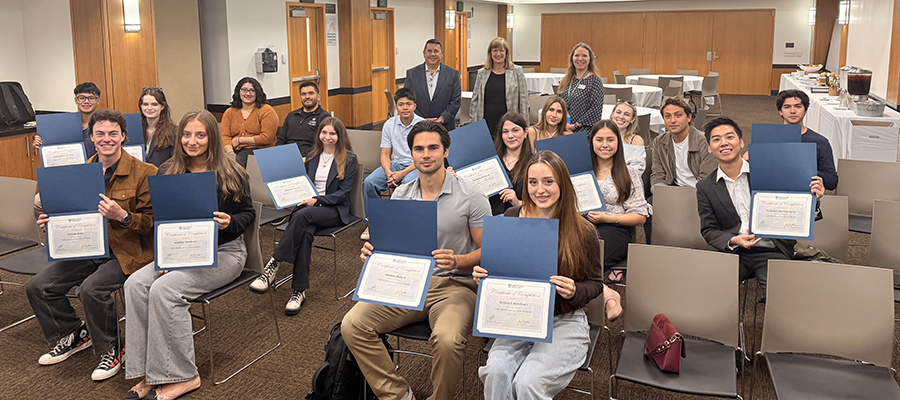 Students with their Real Estate Certificates after completing the program